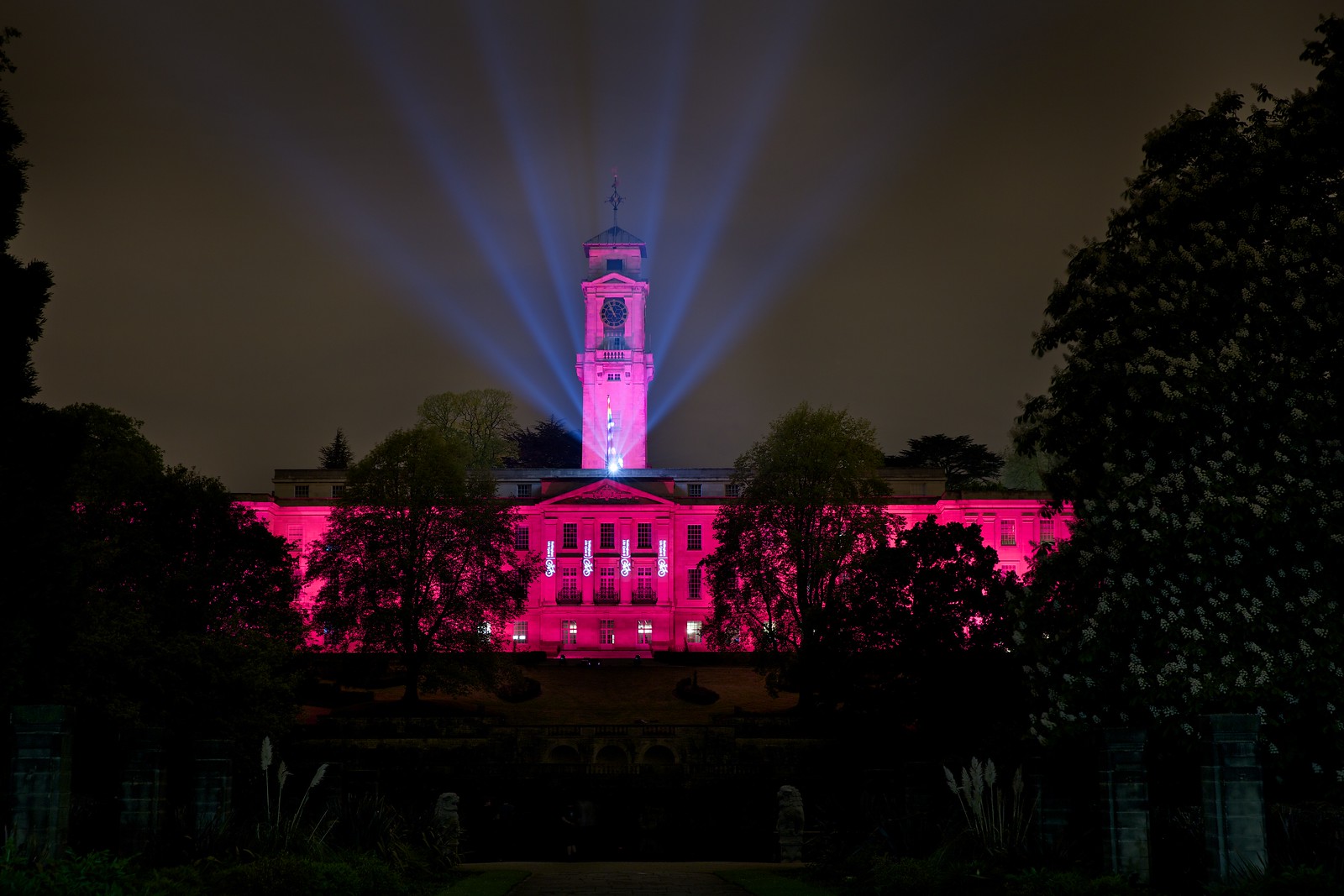 Pink lit building with spotlight on top